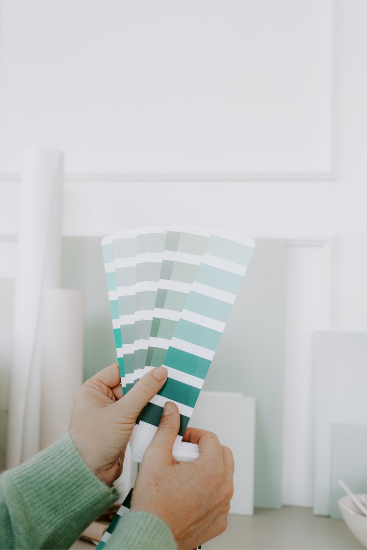 A person holding colour swatches